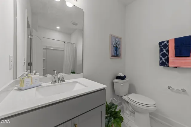 a bathroom with a sink mirror and toilet