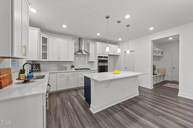 a kitchen with stainless steel appliances a refrigerator sink and cabinets