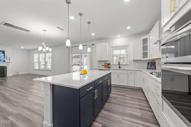 a kitchen with a sink a counter top space stainless steel appliances and cabinets