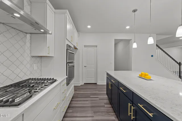 a kitchen with stainless steel appliances granite countertop a sink and a stove