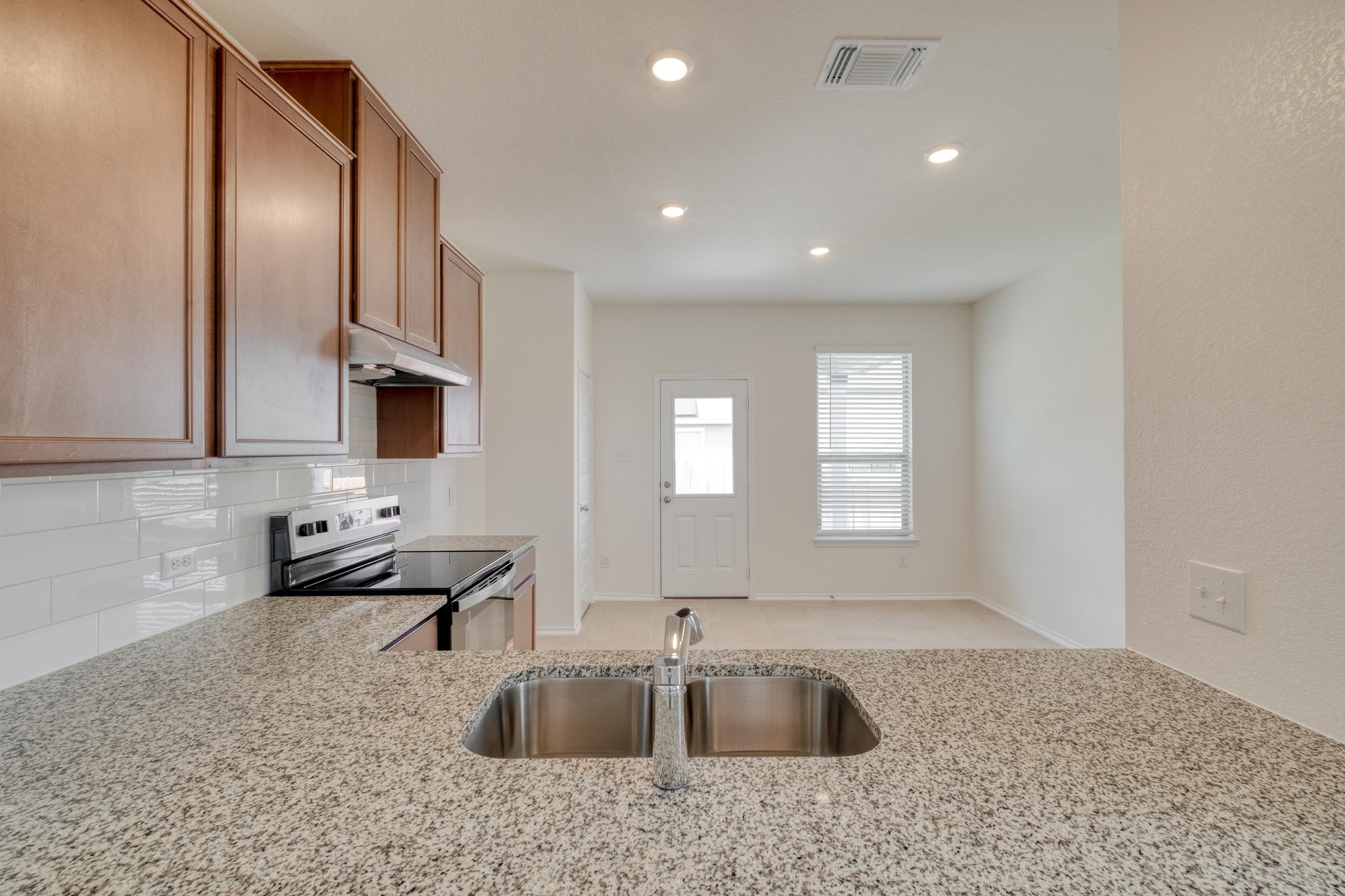 280 Feathers Street Jarrell, TX 76537 - Photo 10 of 28 a kitchen with stainless steel appliances granite countertop a sink and a granite counter tops