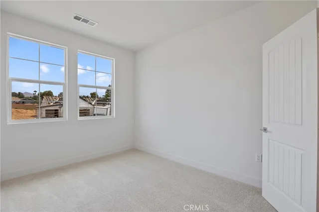 a spacious bedroom with a bed and a couch