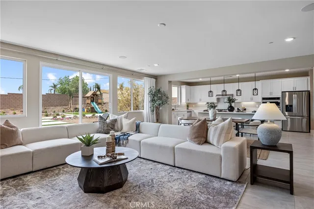 a kitchen with granite countertop stainless steel appliances a table and chairs in it