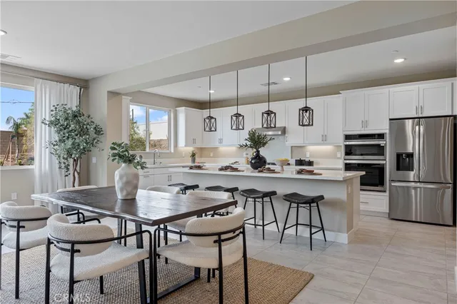 a kitchen with granite countertop white cabinets and sink