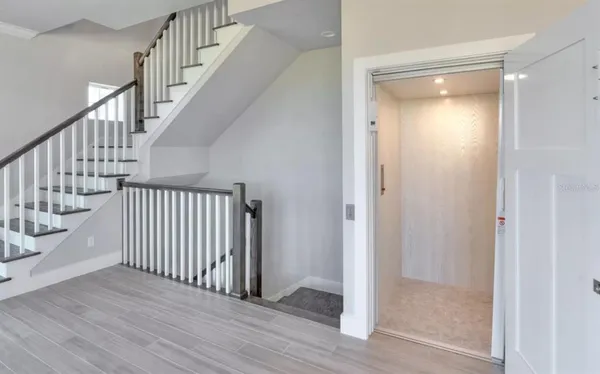 a view of an entryway with wooden floor