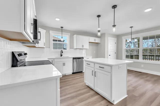 a kitchen with a sink stove and cabinets