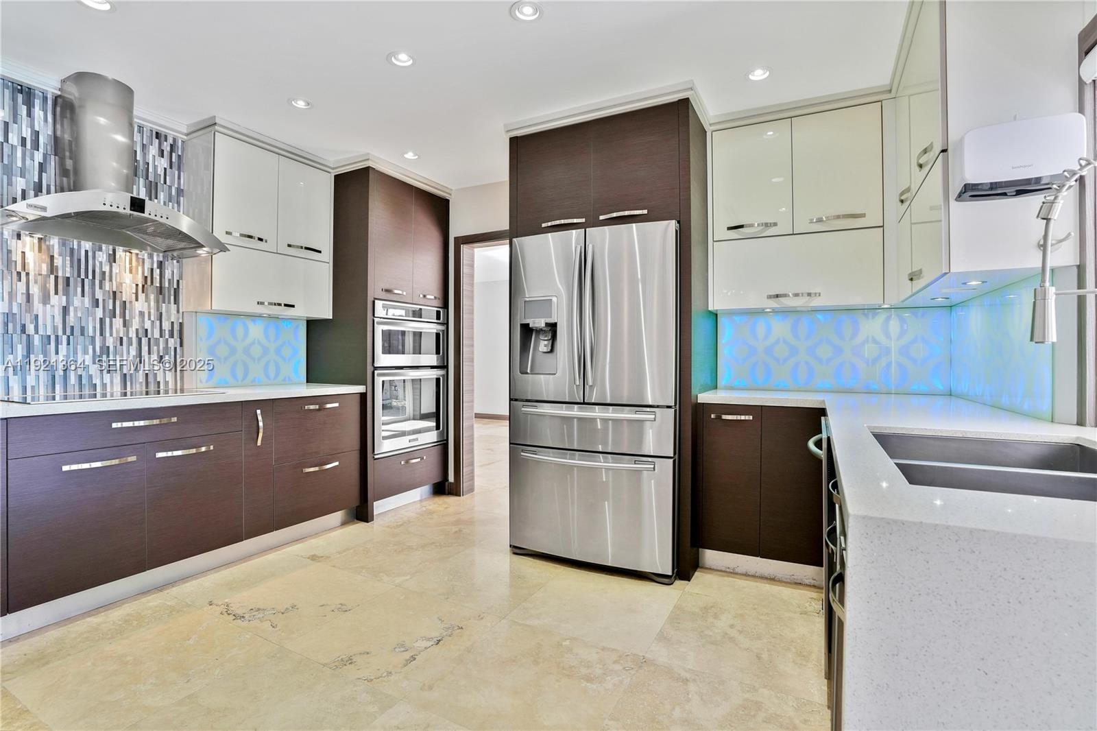 2130 Northeast 122nd Road North Miami, FL 33181 - Photo 14 of 86 a kitchen with stainless steel appliances granite countertop a refrigerator sink and cabinets