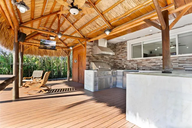a view of an empty room with window and chandelier fan