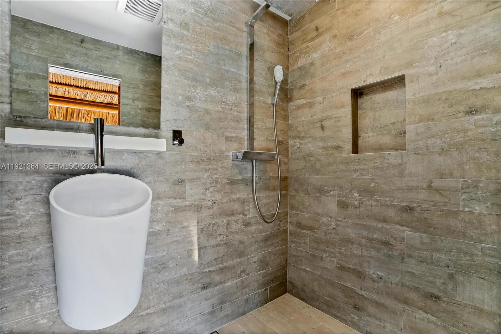 2130 Northeast 122nd Road North Miami, FL 33181 - Photo 32 of 86 a bathroom with a sink a toilet and mirror