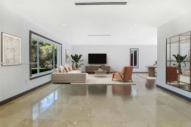 a view of a livingroom with furniture and a window