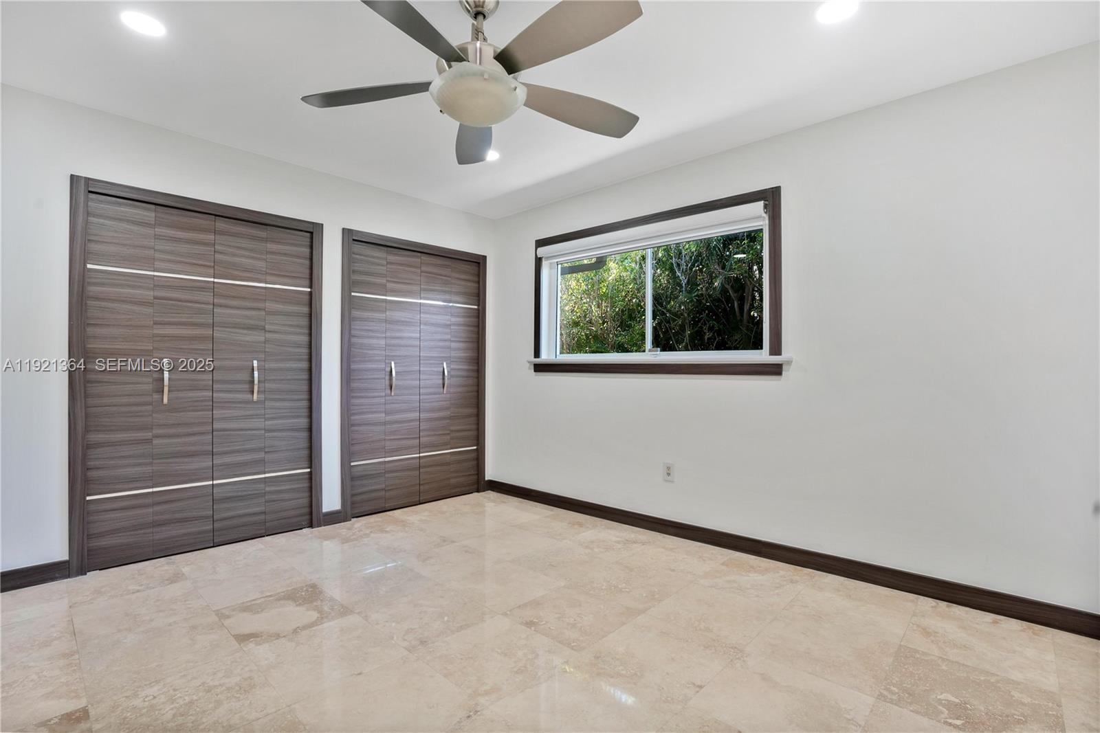 2130 Northeast 122nd Road North Miami, FL 33181 - Photo 54 of 86 an empty room with windows and fan