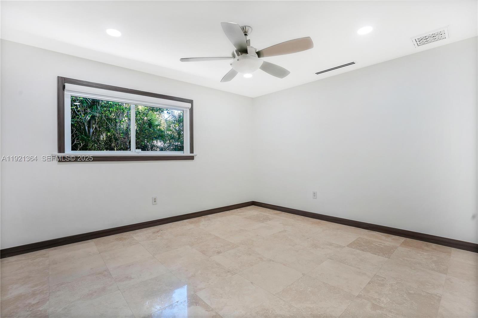 2130 Northeast 122nd Road North Miami, FL 33181 - Photo 58 of 86 an empty room with a window and a fan