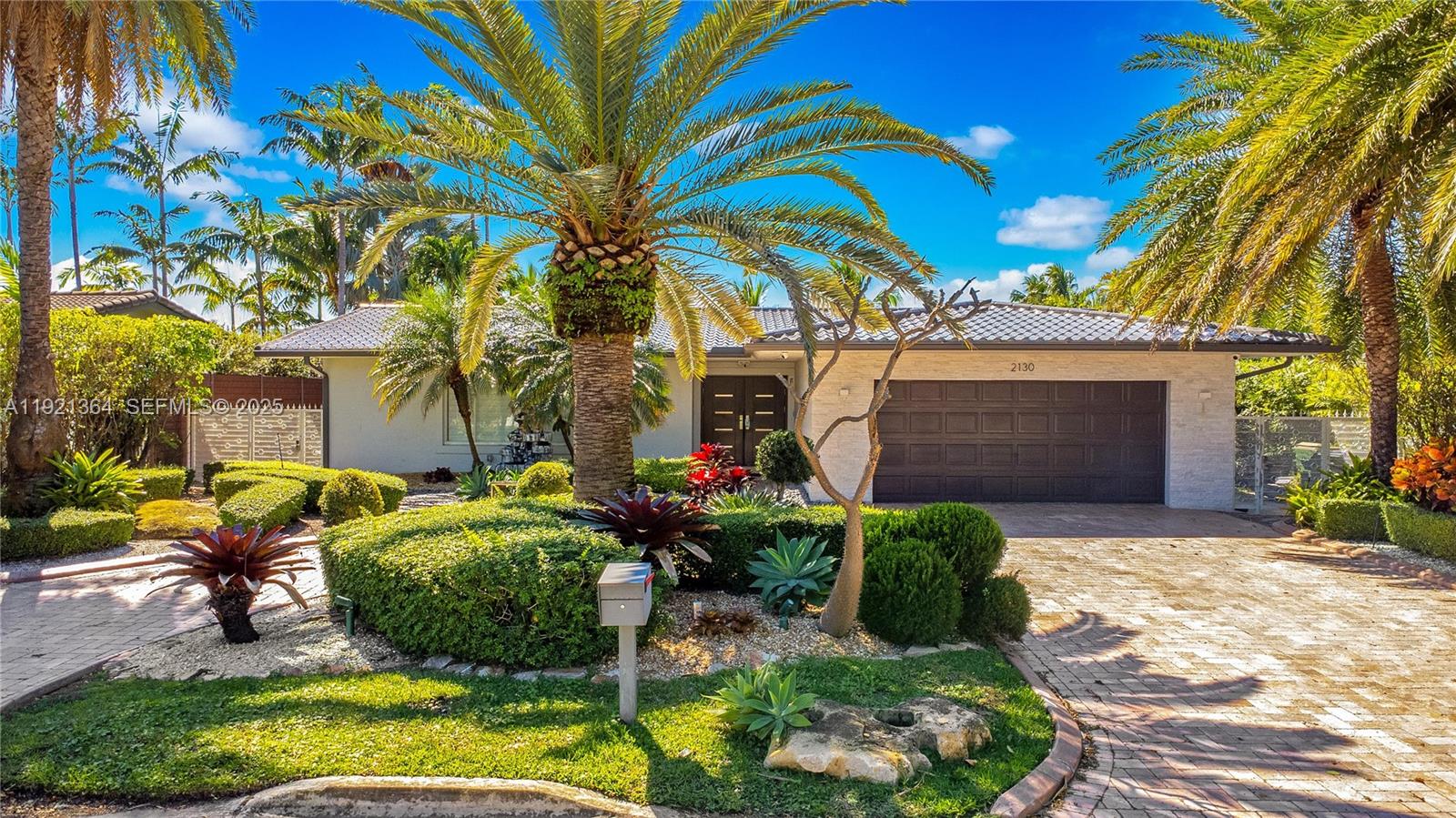 2130 Northeast 122nd Road North Miami, FL 33181 - Photo 76 of 86 a front view of a house with garden