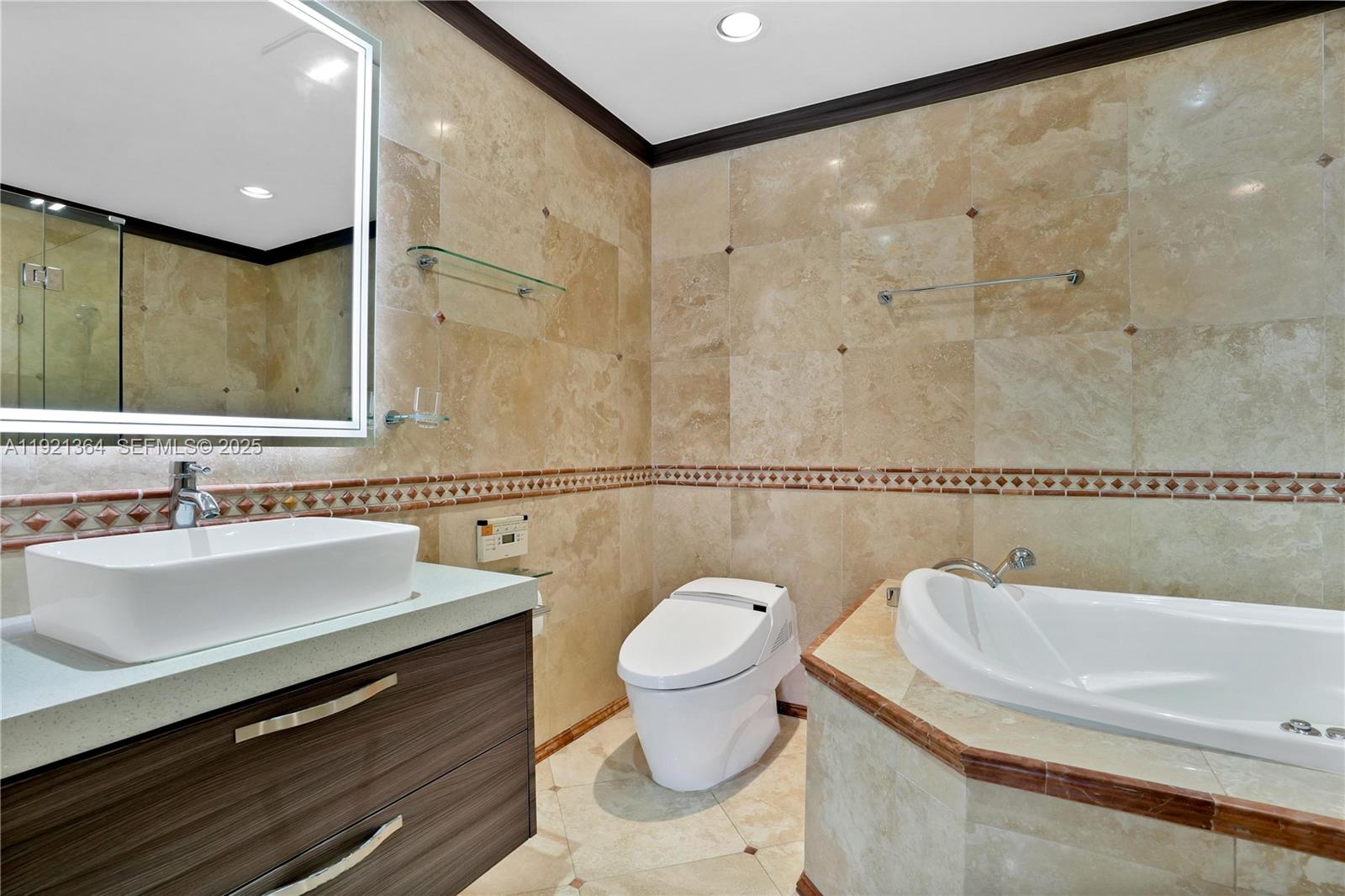 2130 Northeast 122nd Road North Miami, FL 33181 - Photo 8 of 86 a bathroom with a sink a toilet and a mirror