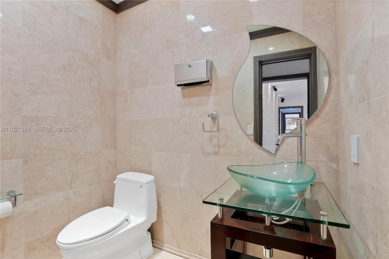 2130 Northeast 122nd Road North Miami, FL 33181 - Photo 10 of 86 a bathroom with a toilet a sink and mirror