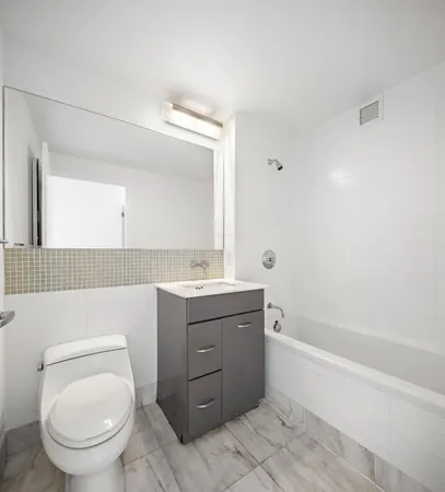 a bathroom with a toilet a sink and bathtub