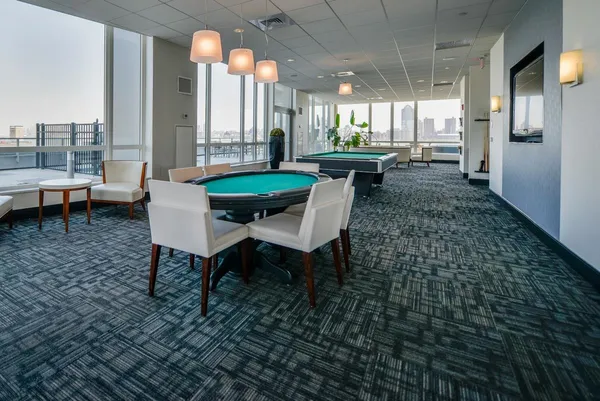 a dining room with furniture and a floor to ceiling window