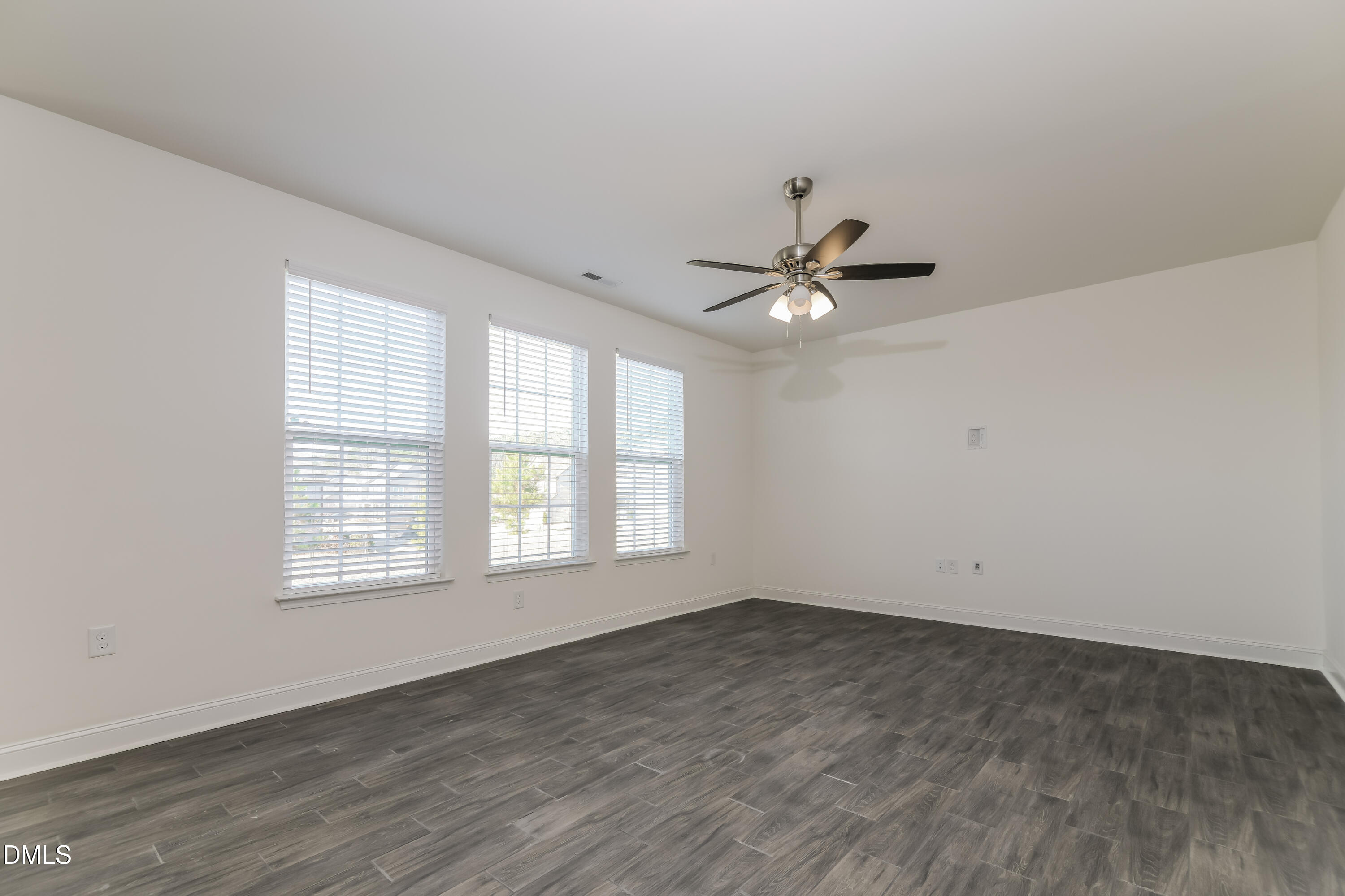20 Misty Grove Trail Franklinton, NC 27525 - Photo 3 of 17 an empty room with wooden floor and windows