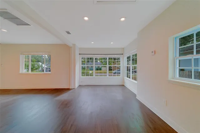 a living room with furniture wooden floor and a table
