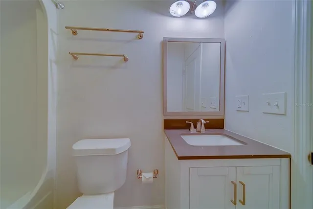 an empty room with a window and a ceiling fan