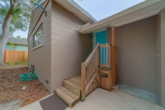 a backyard of a house with table and chairs