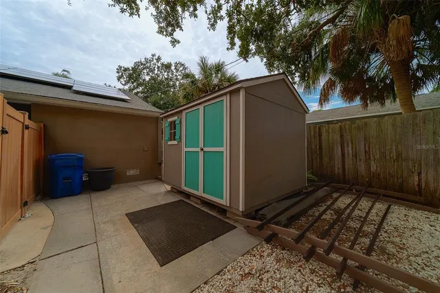 a backyard of a house with plants and tree