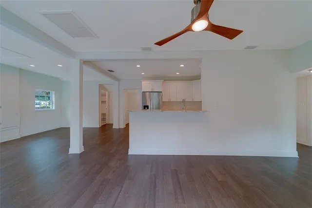 a view of kitchen with a refrigerator wooden floor and window