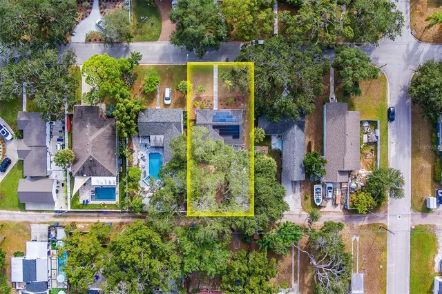 an aerial view of a house with a yard