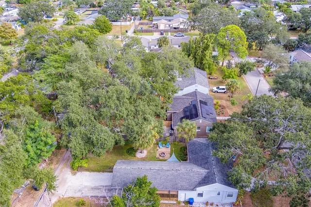 an aerial view of a house with a yard