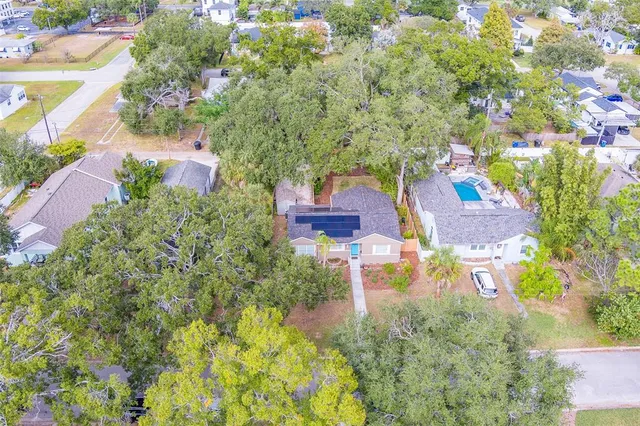 an aerial view of residential houses with yard and swimming pool