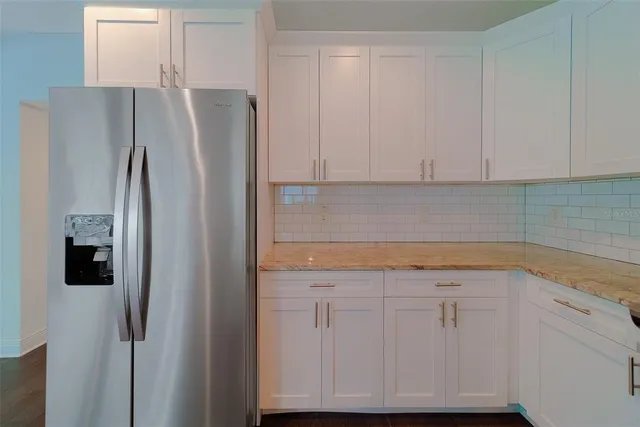 an empty room with wooden floor and a window