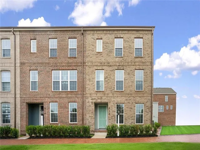 a front view of a brick building with yard