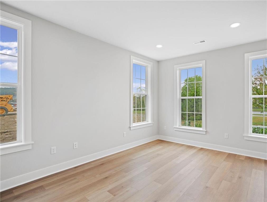 212 Oliver Way Cranberry Township, PA 16066 - Photo 21 of 49 a view of an empty room with wooden floor and a window