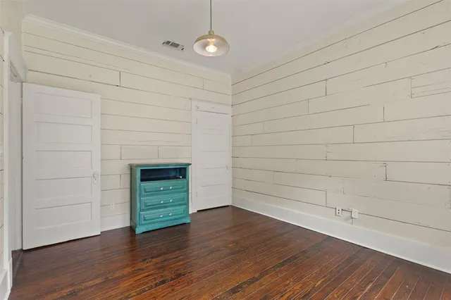 a view of an empty room with a fireplace and a window