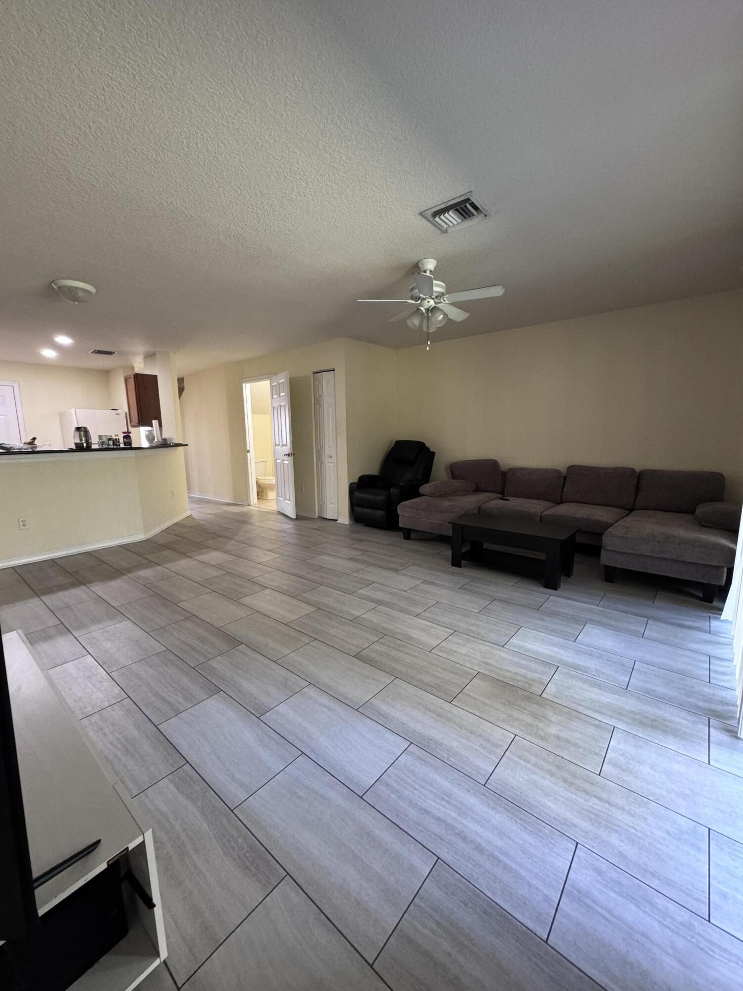 2755 Southeast Birmingham Drive, Unit 3 Stuart, FL 34994 - Photo 11 of 23 a living room with furniture and a chandelier