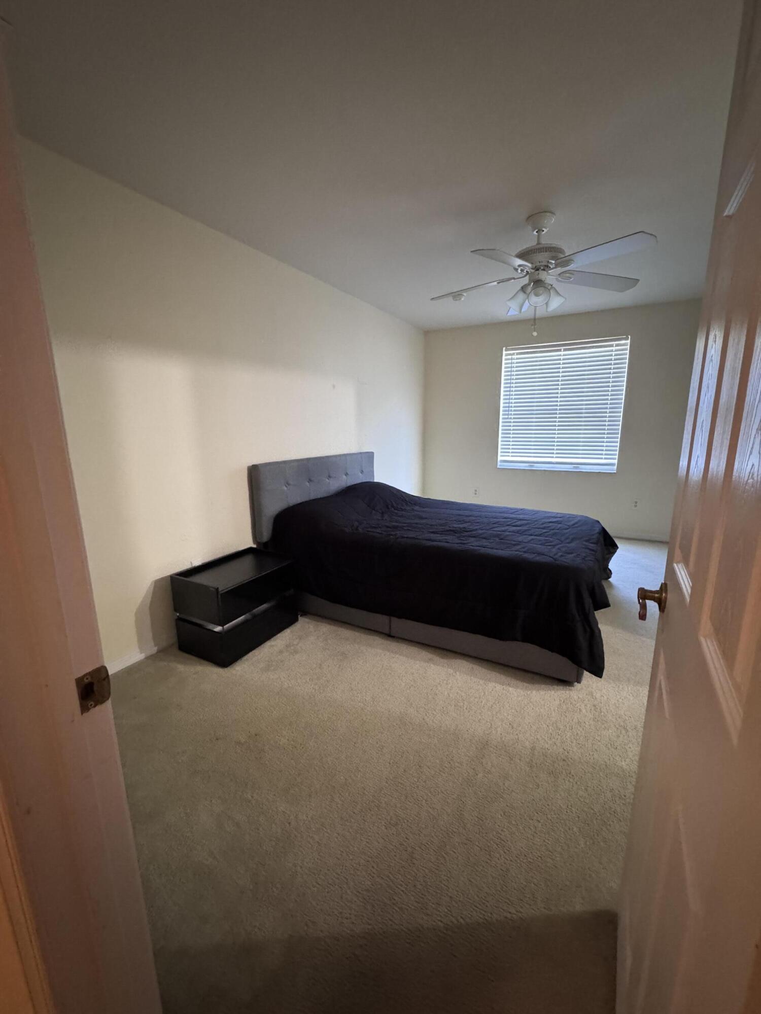 2755 Southeast Birmingham Drive, Unit 3 Stuart, FL 34994 - Photo 14 of 23 a bedroom with a bed and a window