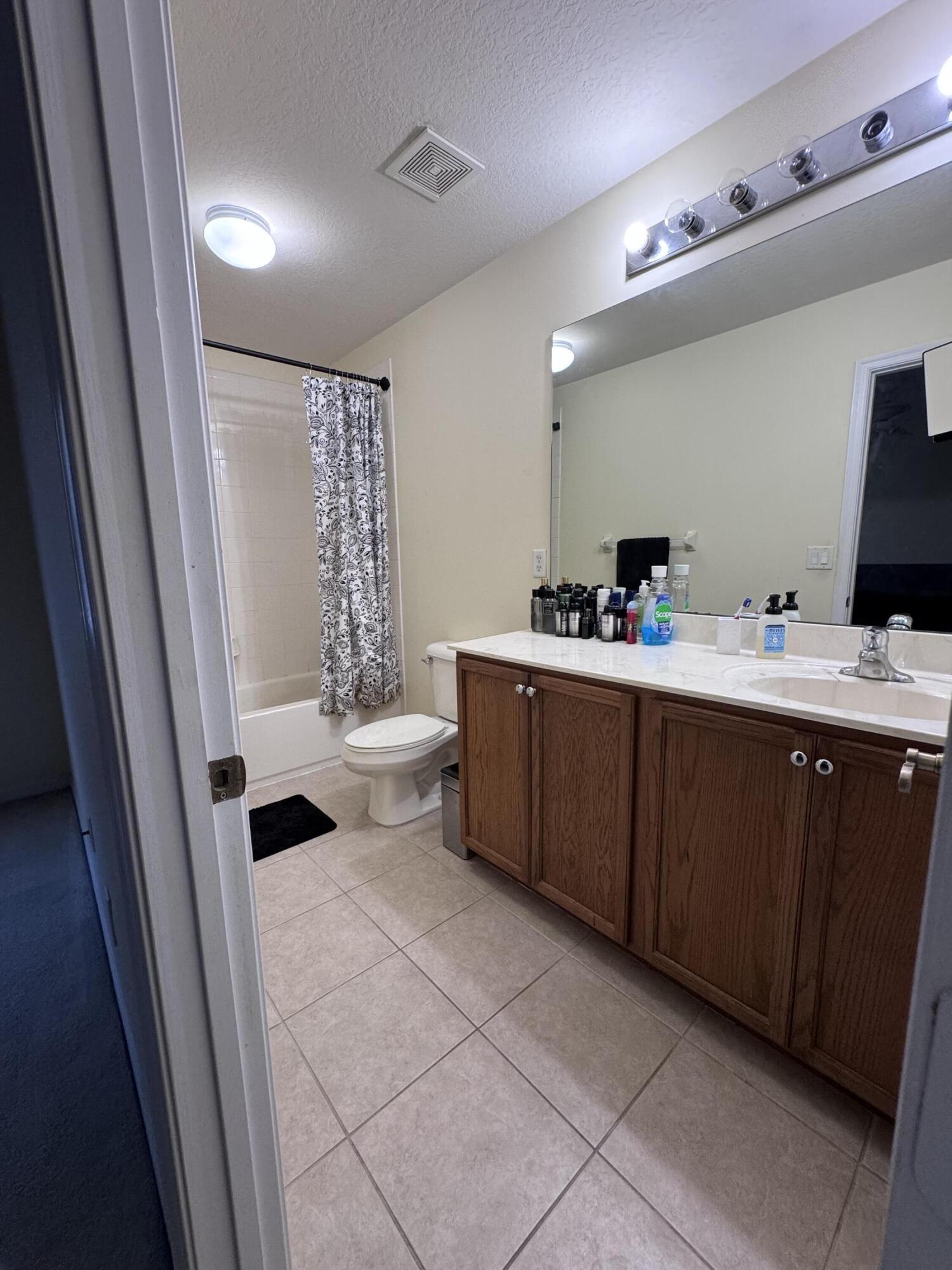 2755 Southeast Birmingham Drive, Unit 3 Stuart, FL 34994 - Photo 15 of 23 a room with a baby bed a desk and chair