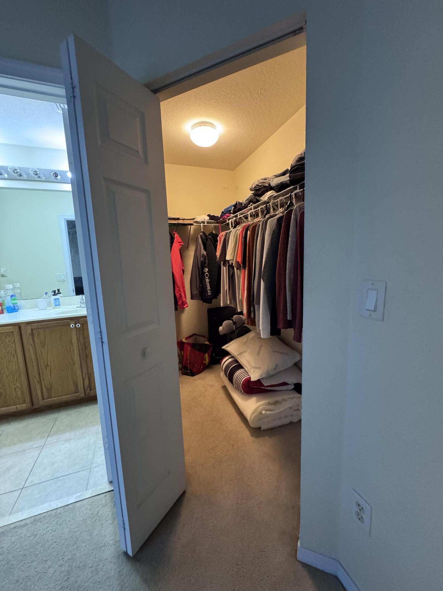 2755 Southeast Birmingham Drive, Unit 3 Stuart, FL 34994 - Photo 16 of 23 a view of walk in closet with clothes and shoes