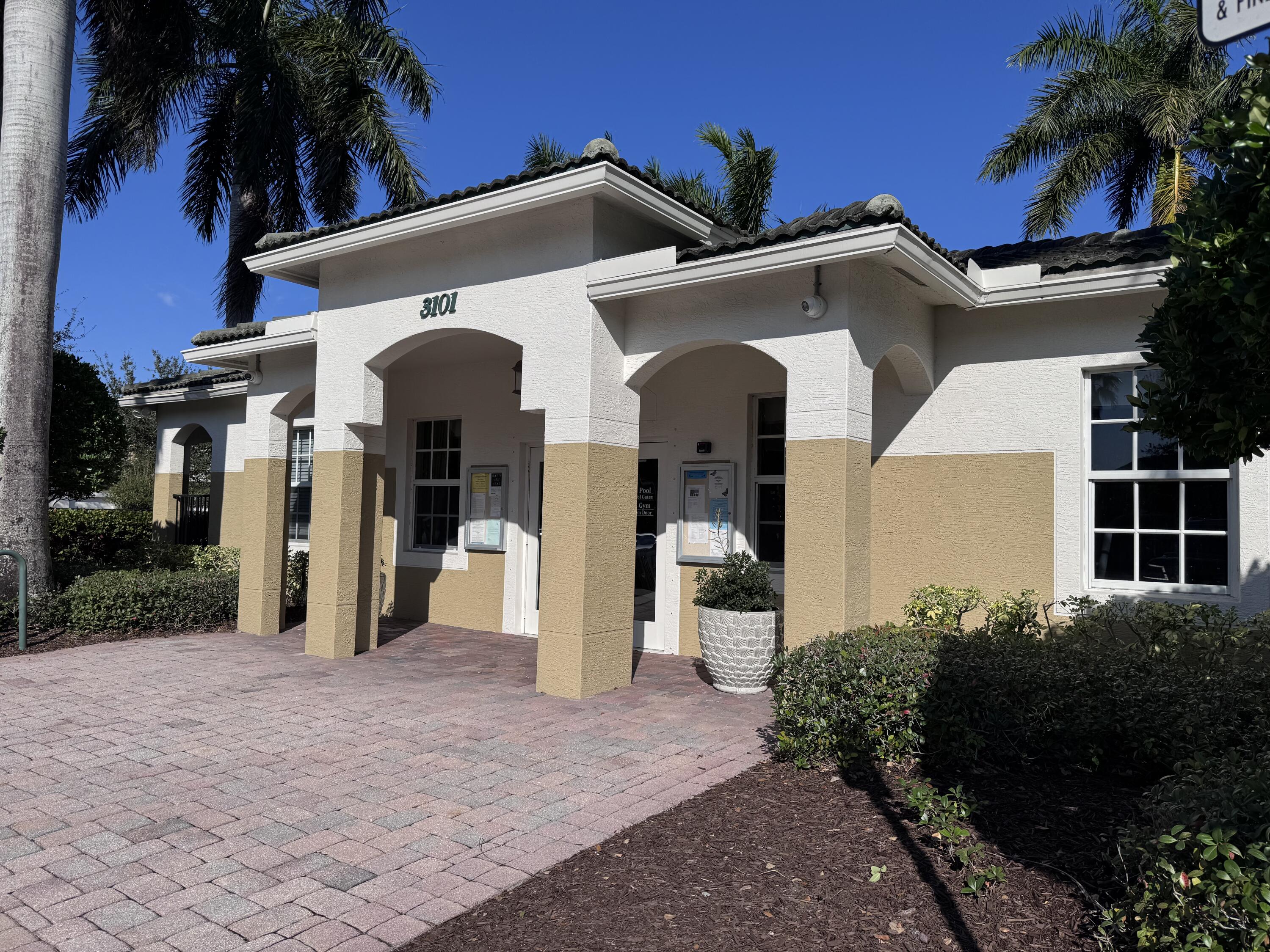 2755 Southeast Birmingham Drive, Unit 3 Stuart, FL 34994 - Photo 21 of 23 a view of a house with a yard and potted plants