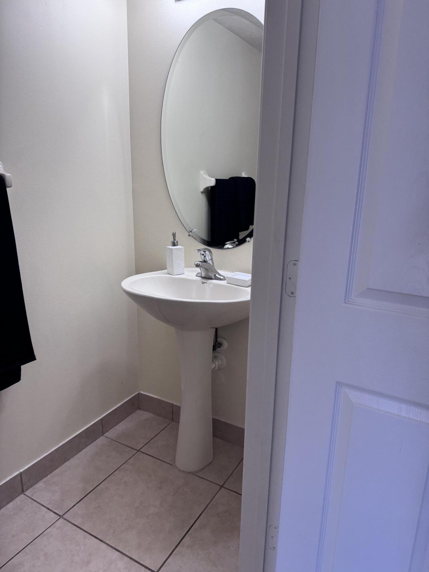 2755 Southeast Birmingham Drive, Unit 3 Stuart, FL 34994 - Photo 8 of 23 a bathroom with a sink and mirror