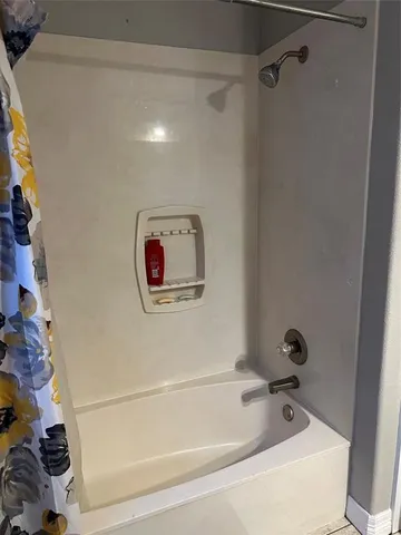 a bathroom with a bathtub and a shower