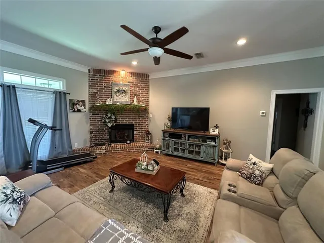 a living room with furniture a flat screen tv and a fireplace