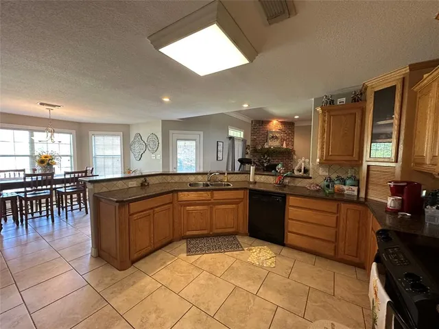 a large kitchen with lots of counter and chairs