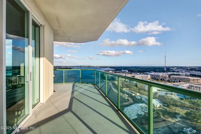 a bedroom with a bed a couch and a flat screen tv
