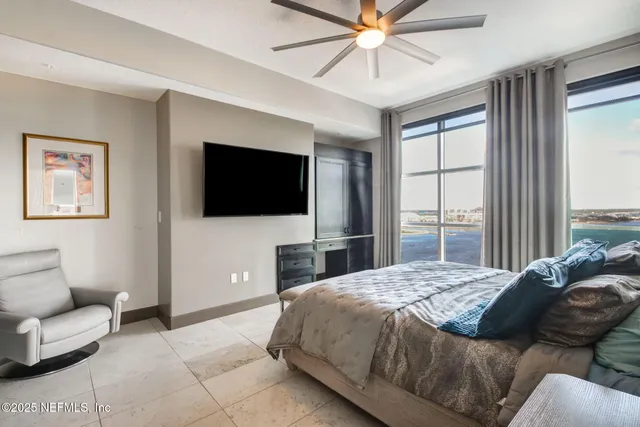 a bedroom with a bed and a chandelier