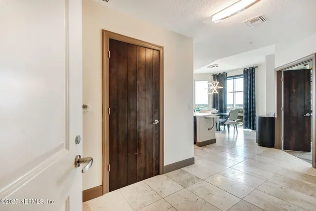 a view of a hallway with living room and dining room view