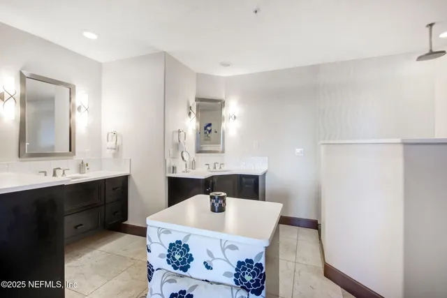 a bathroom with a double vanity sink and mirror