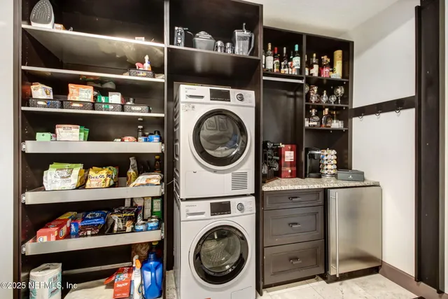 a view of a hallway to a livingroom with furniture