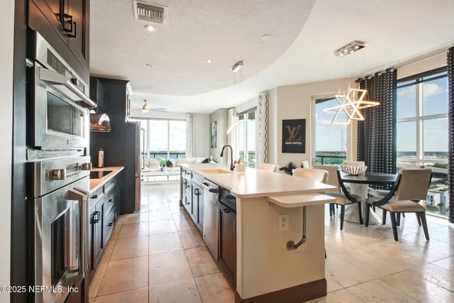 a kitchen with stainless steel appliances granite countertop a white cabinets and a stove