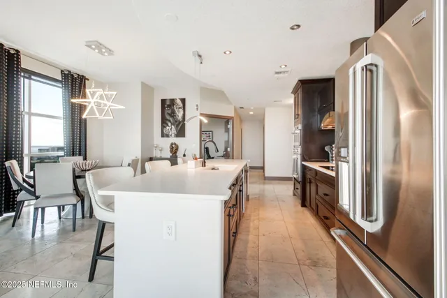 a very nice looking dining room with a large window